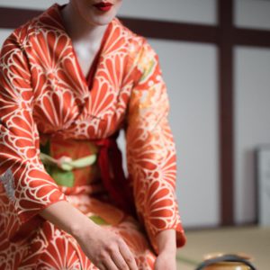 A geisha prepping tea during a tea ceremony.